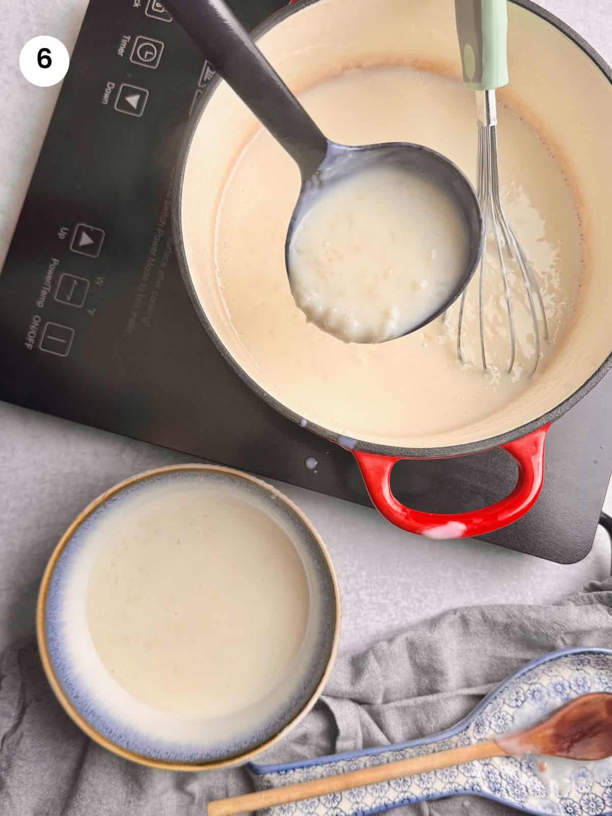 Putting rice pudding to individual bowls.