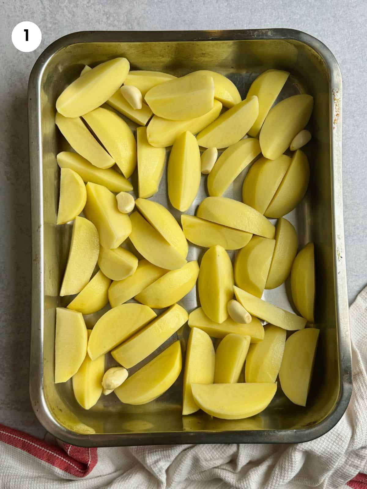 Potatoes and garlic cloves in the tray.