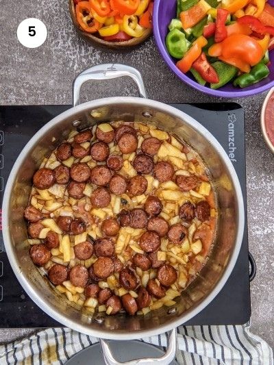 Cook onions and sausages before adding the other veggies.