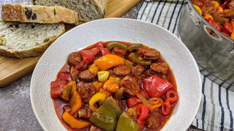 Side picture of served spetzofai in a beige bowl.