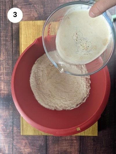 Adding the water and yeast to the flour