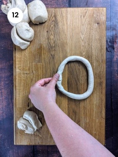 Rolling the dough for sesame bread rings.