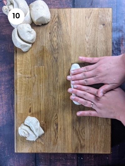 Rolling the dough for sesame bread rings.