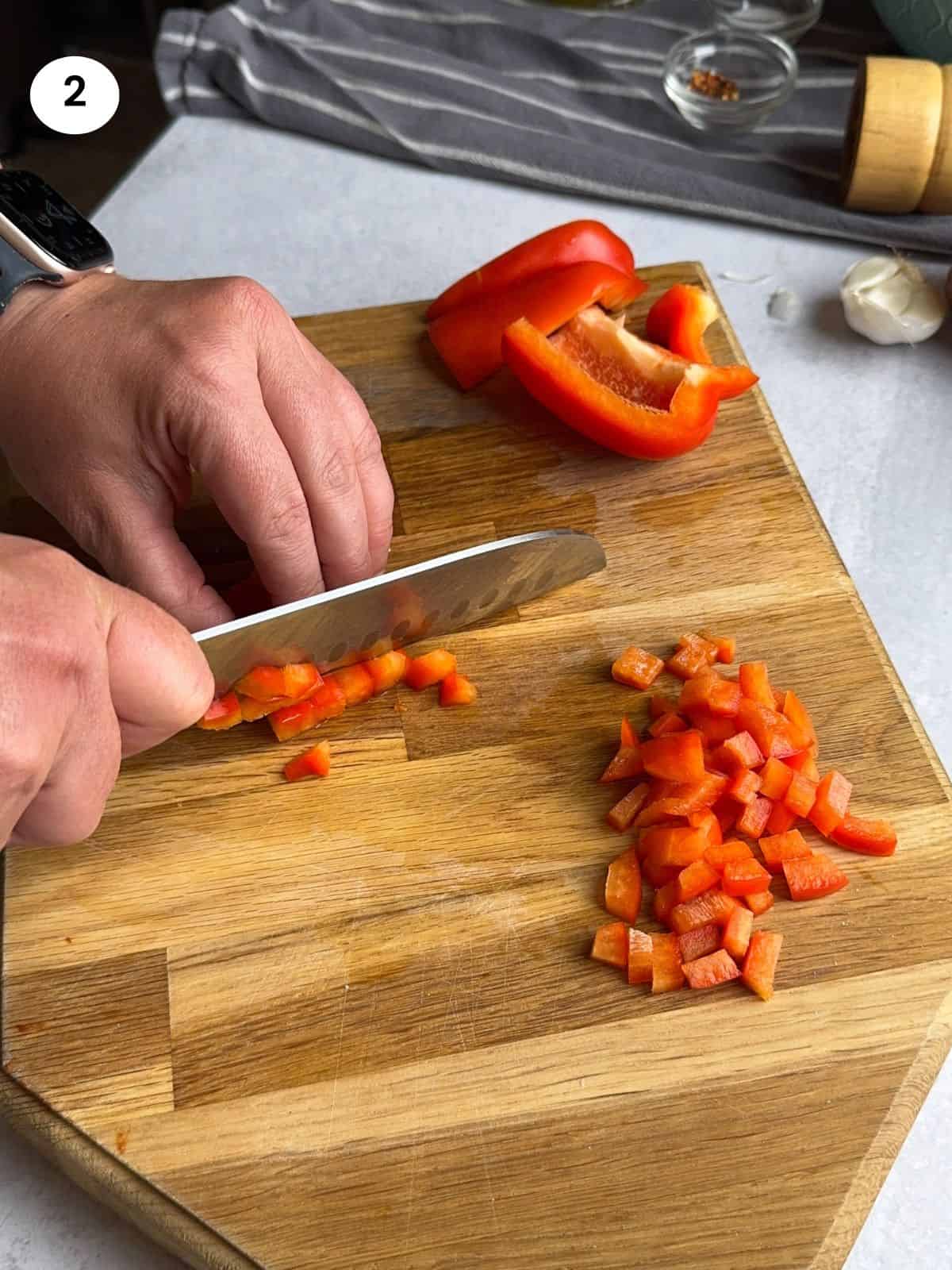 Chopping a bell pepper.