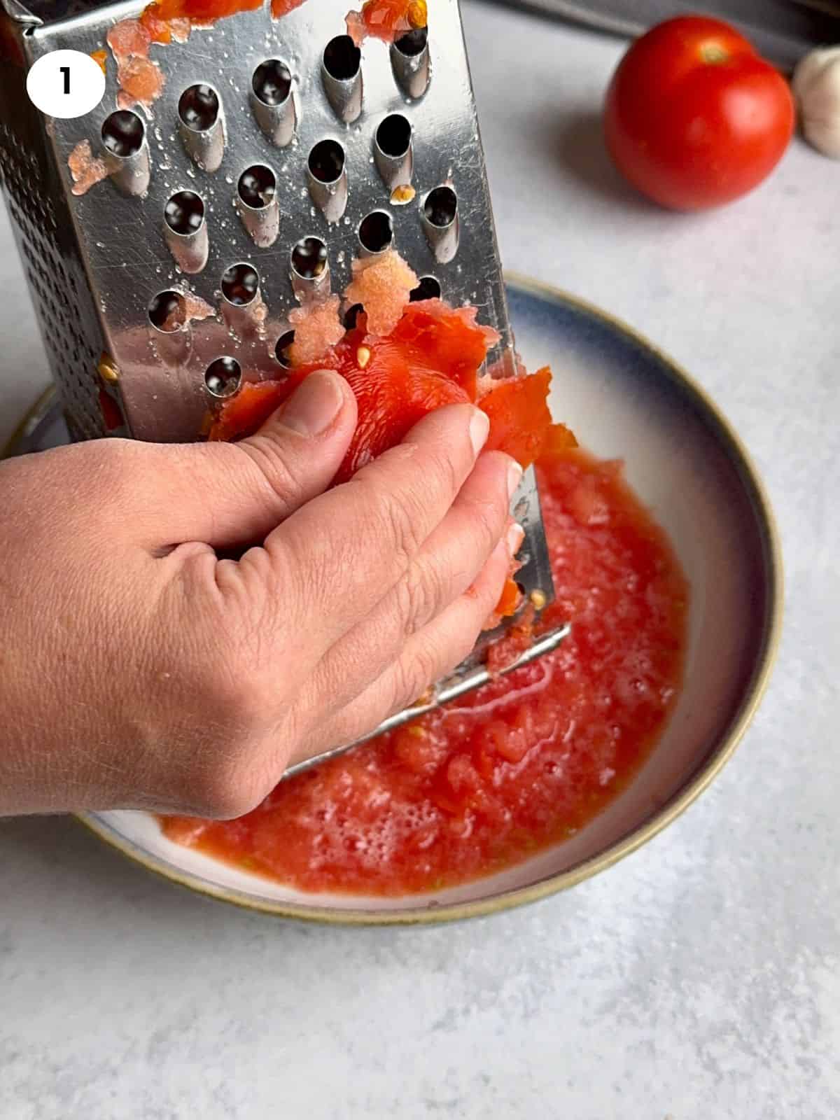Grating a tomato.