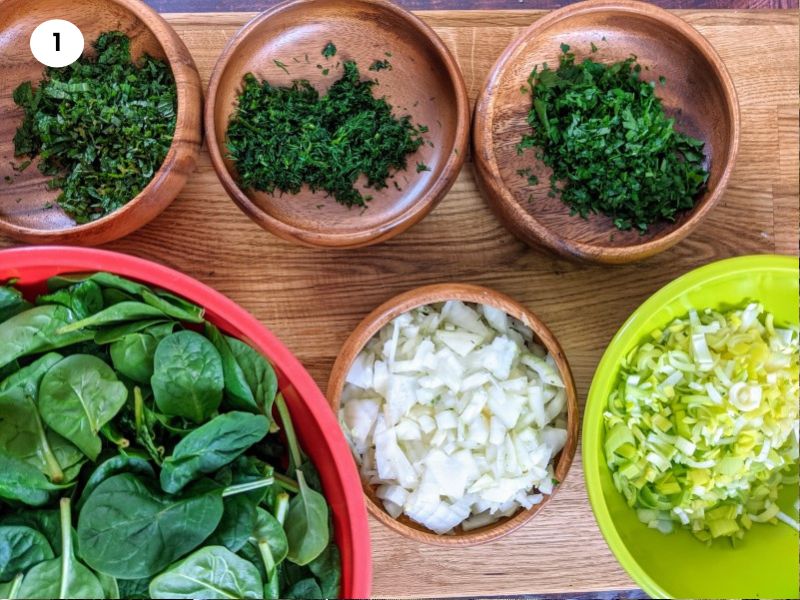 Chopped ingredients for spinach & feta cheese triangles.