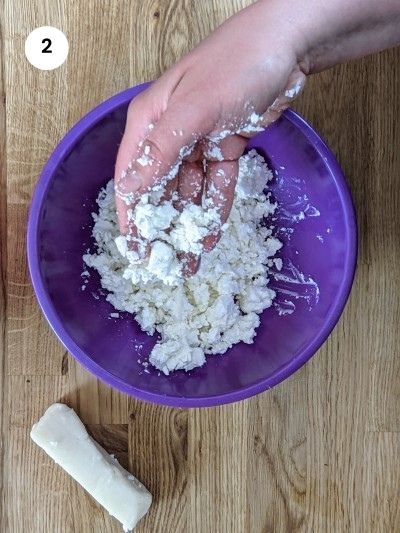 Crumbling feta cheese for spinach & feta cheese triangles.