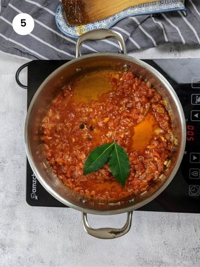 Adding the chopped tomatoes and seasoning.