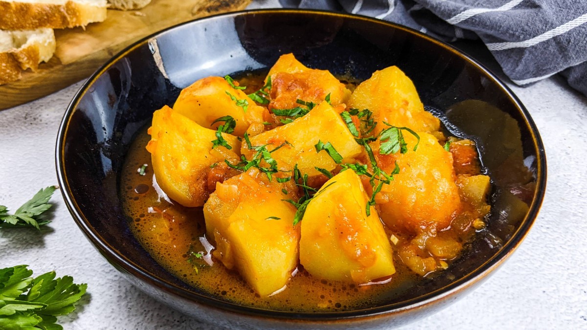 Greek potatoes stew in tomato sauce served in a bowl.