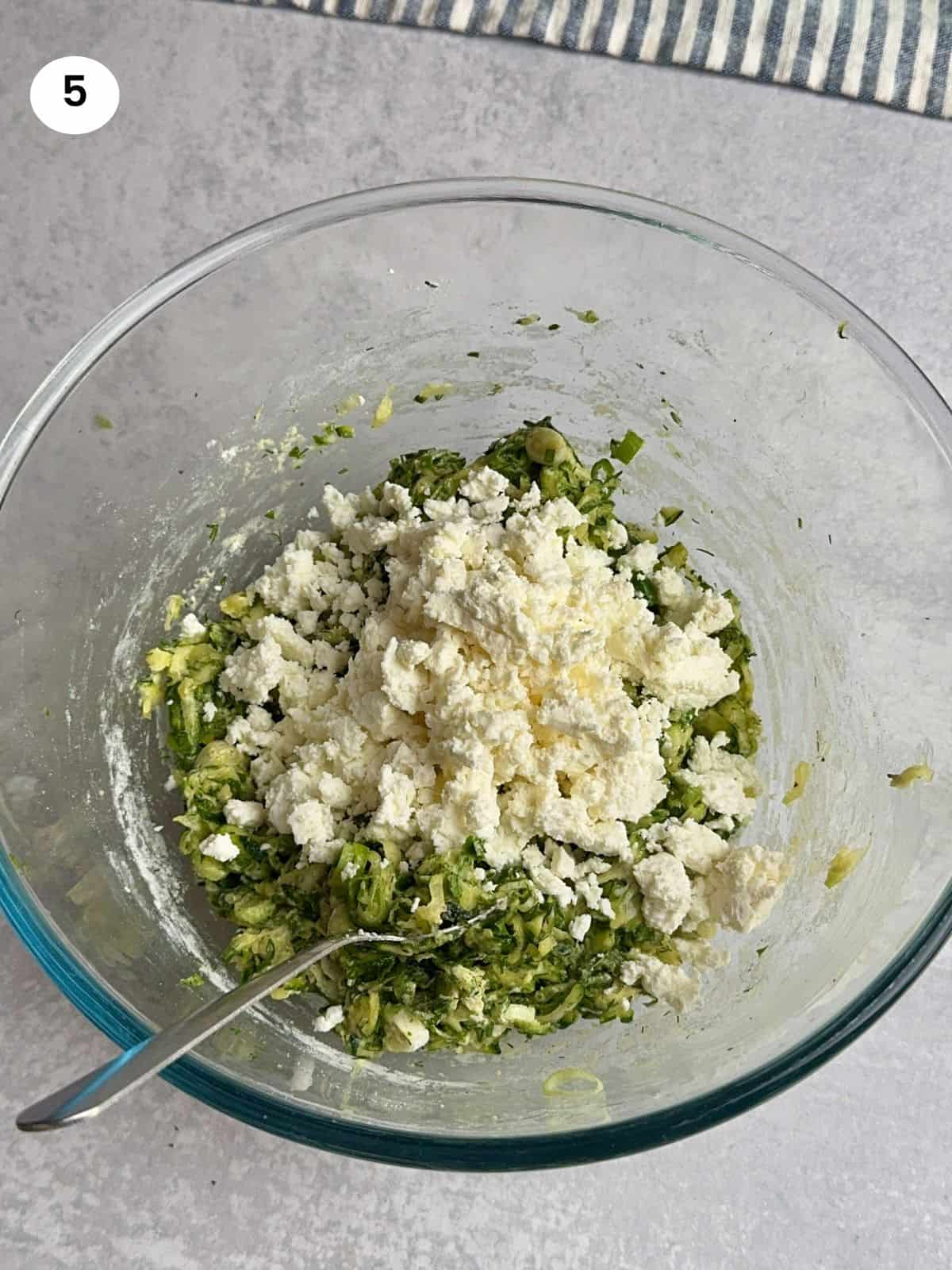 Added crumbled feta cheese to the bowl.