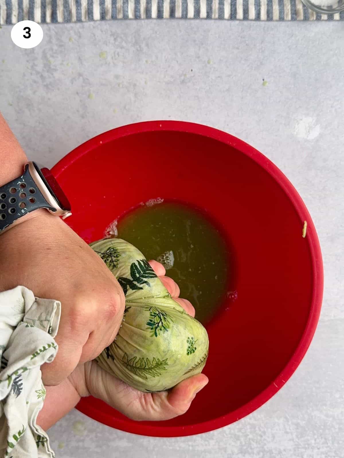 Squeezing the water out of the grated zucchinis.