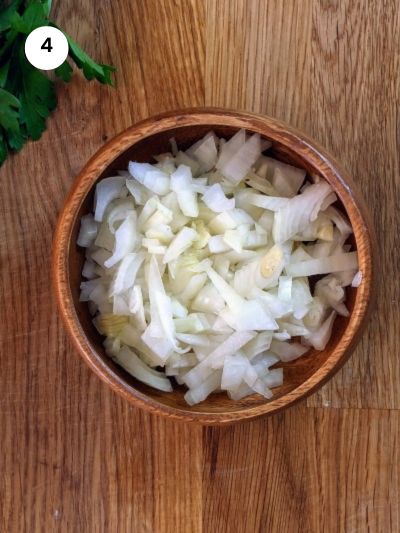 Chopped onion for Greek green beans stew.