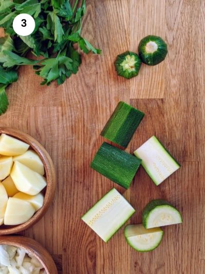 How to prepare and cut the zucchinis for stewed green beans.