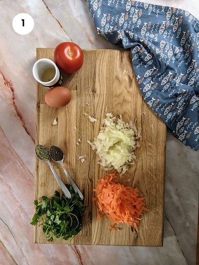 Grating vegetables for the greek burgers.