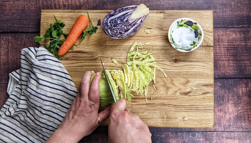 Cutting the cabbage into thin slices Cutting the cabbage into thin slices.
