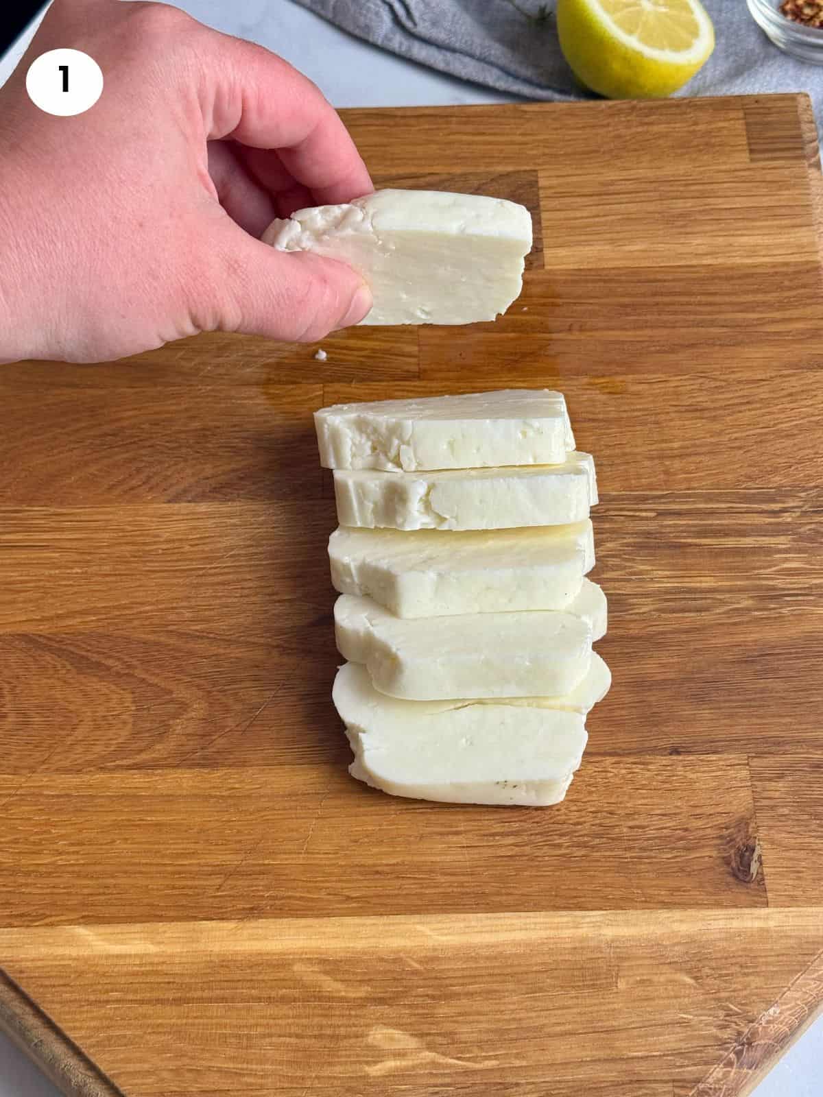 Cutting the halloumi cheese block into slices.