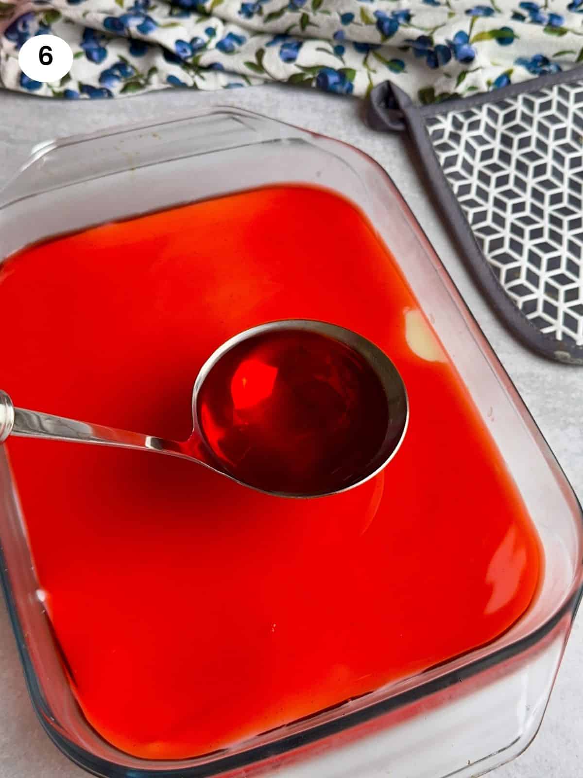 Pouring the jelly on top of the custard.