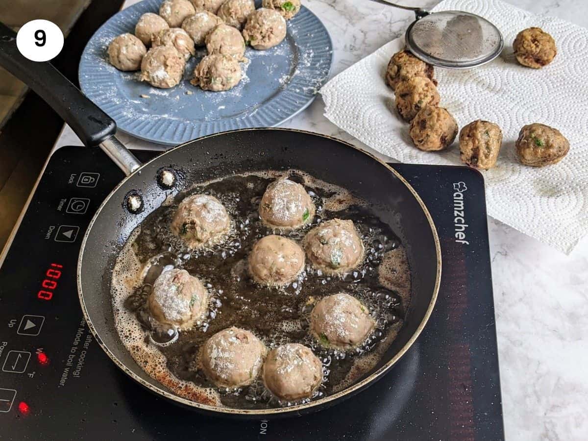 Adding the meatballs to the hot oil pan.