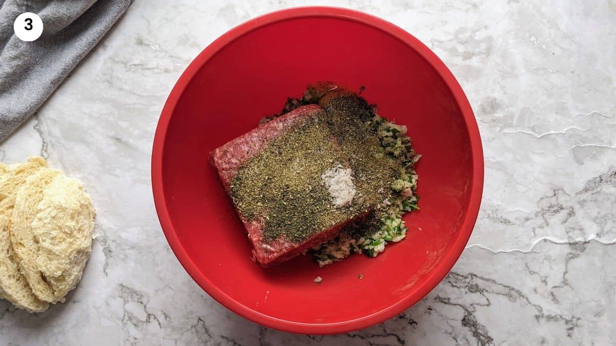 Mixing the blended ingredients with the ground beef, egg and herbs.