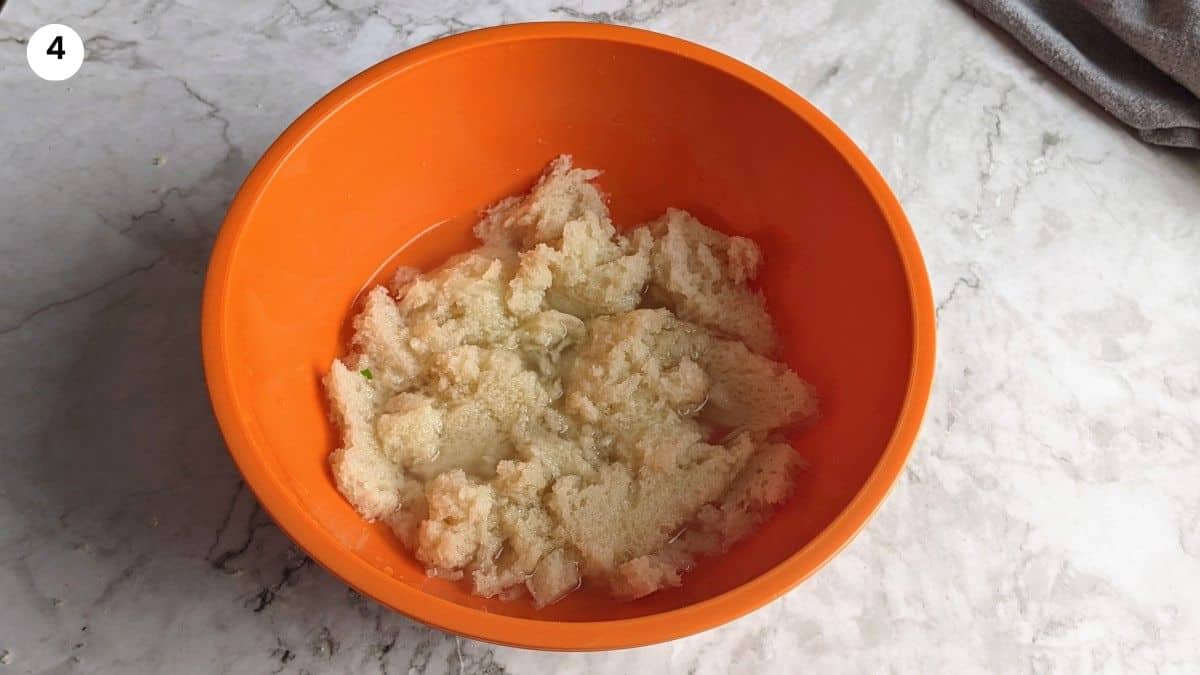 Bread soaking in bowl filled with water.