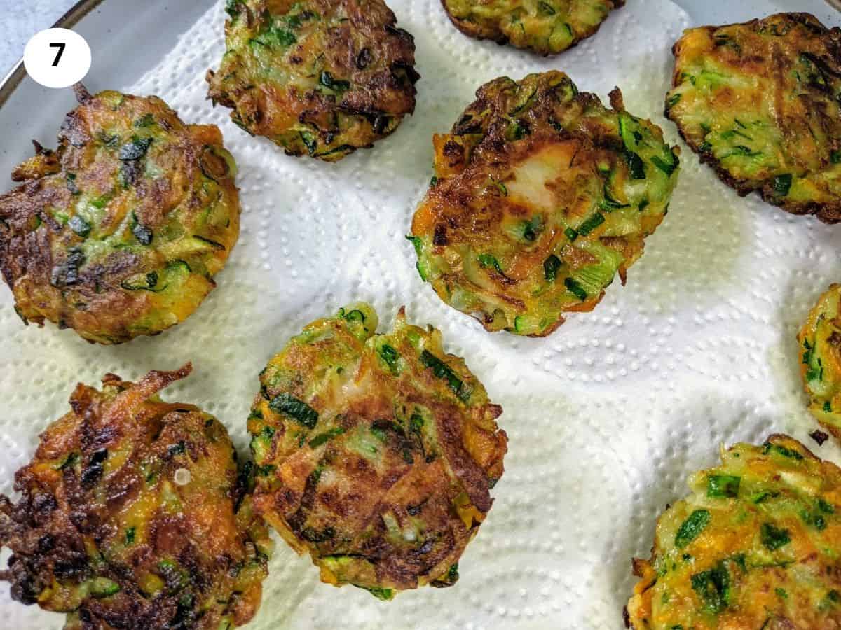 Kohlrabi fritters resting on paper towel.