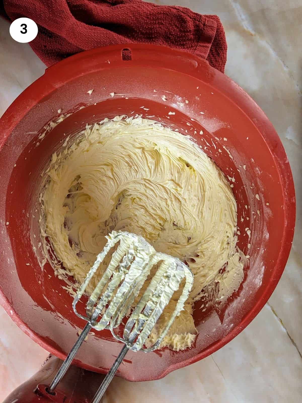 Mixing butter and sugar until light and fluffy.