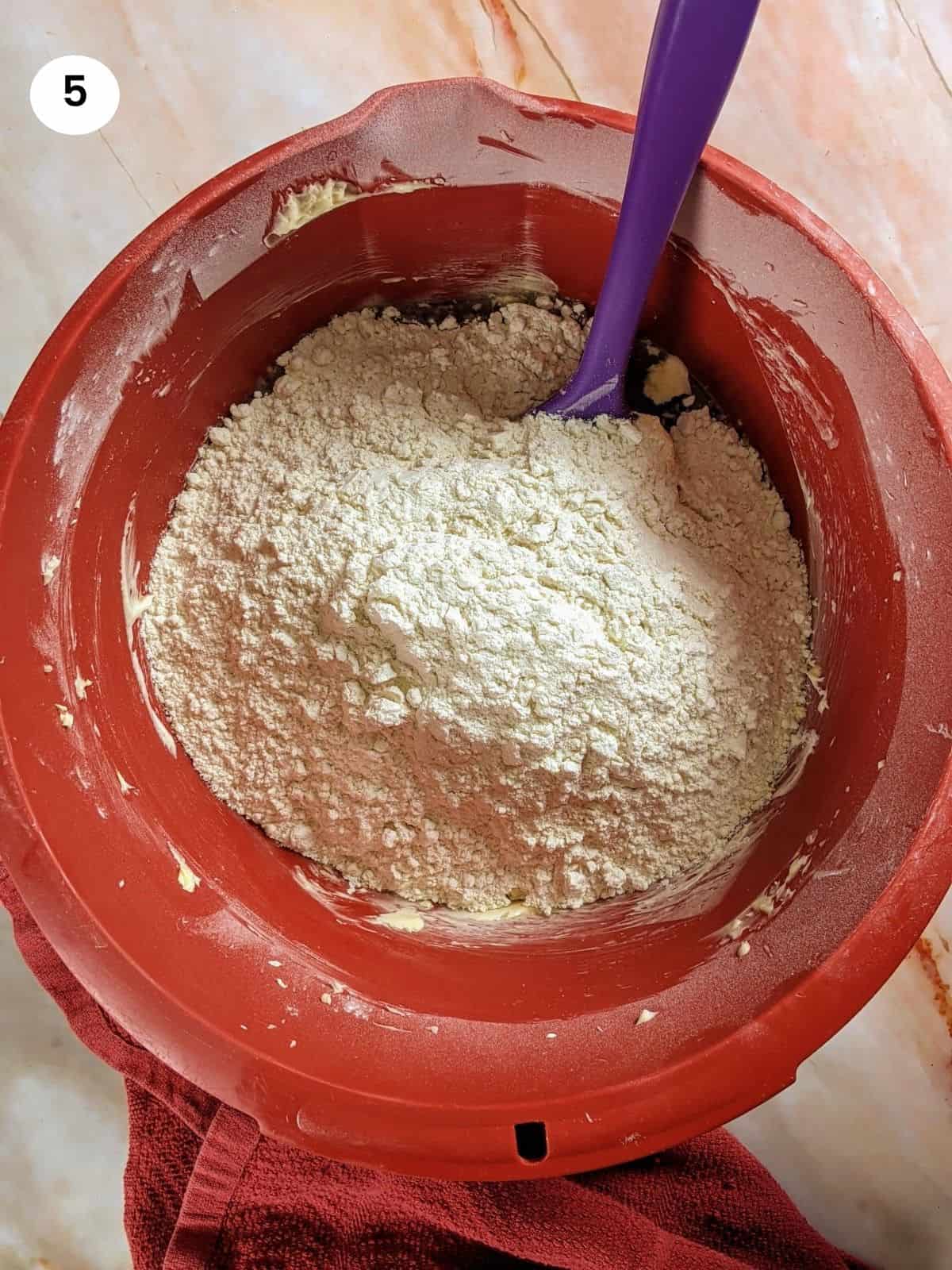 Adding the flour for kourabiedes.