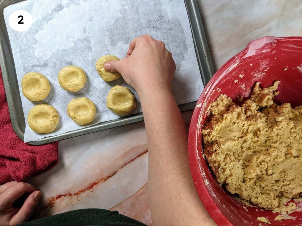 Pressing the center of the cookie with my finger.