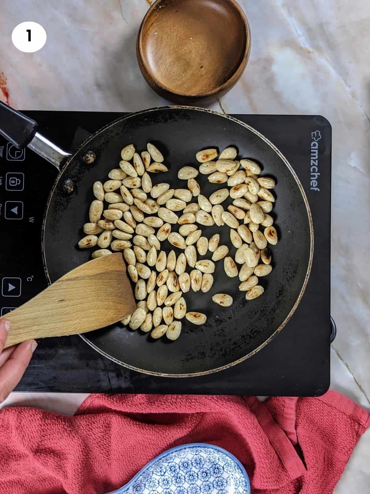 Toasting the almonds for kourabiedes recipe.