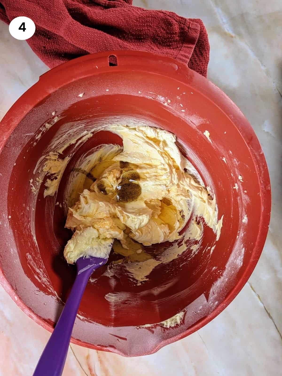 Adding the wet ingredients for the recipe for kourabiedes.