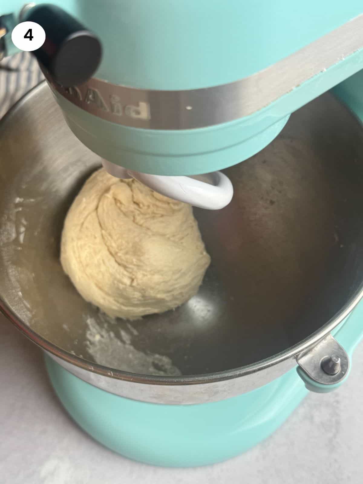 Kneading the dough using a stand mixer with the hook attachment.