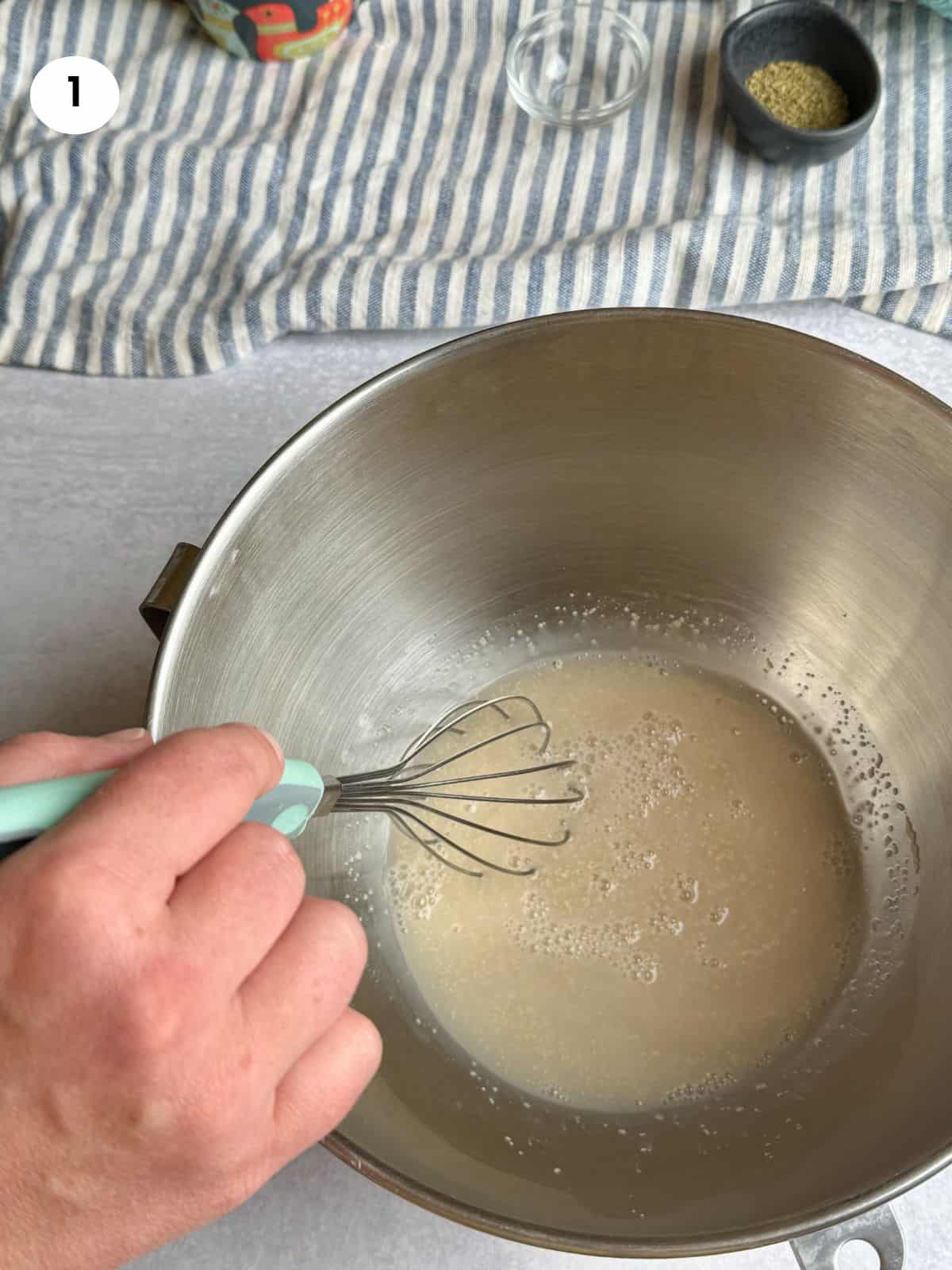 Mixing the yeast and lukewarm water in a bowl.