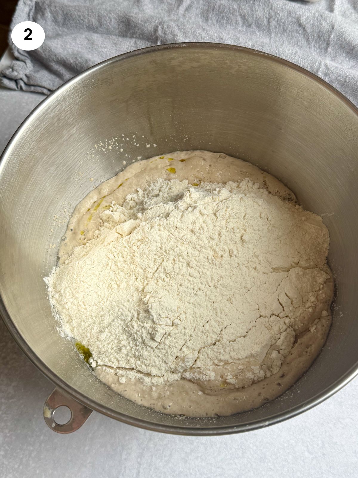 Added the dry ingredients to the bowl with the yeast mixture.