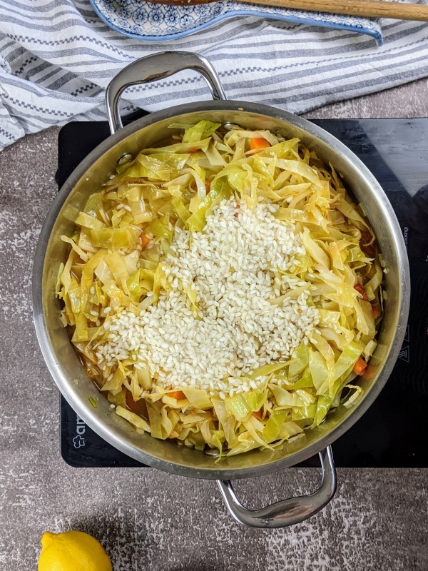 Adding the rice to the pot.