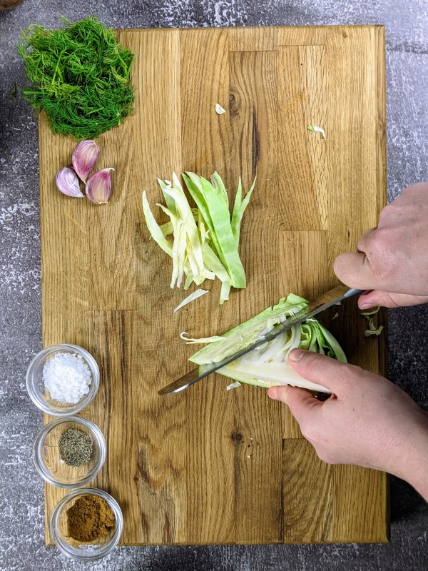 Cutting the cabbage into slices.