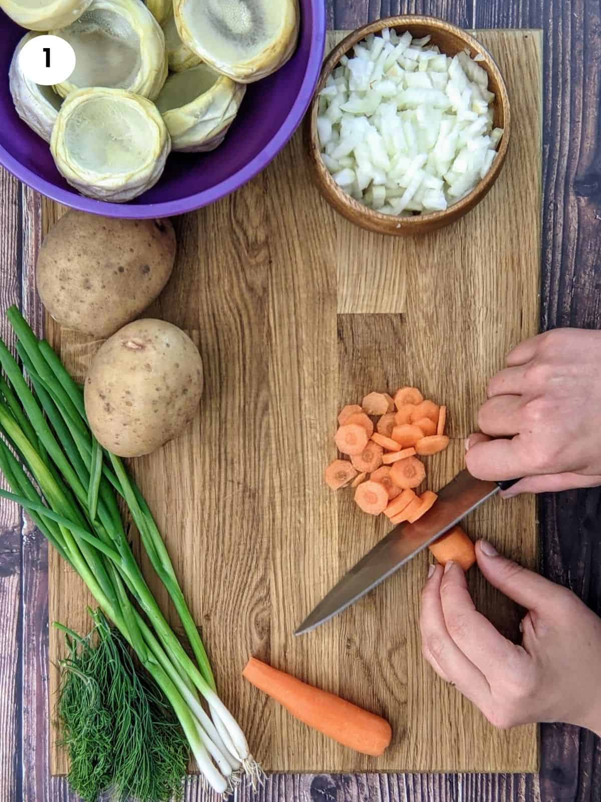Chopping carrots in slices for artichoke stew.