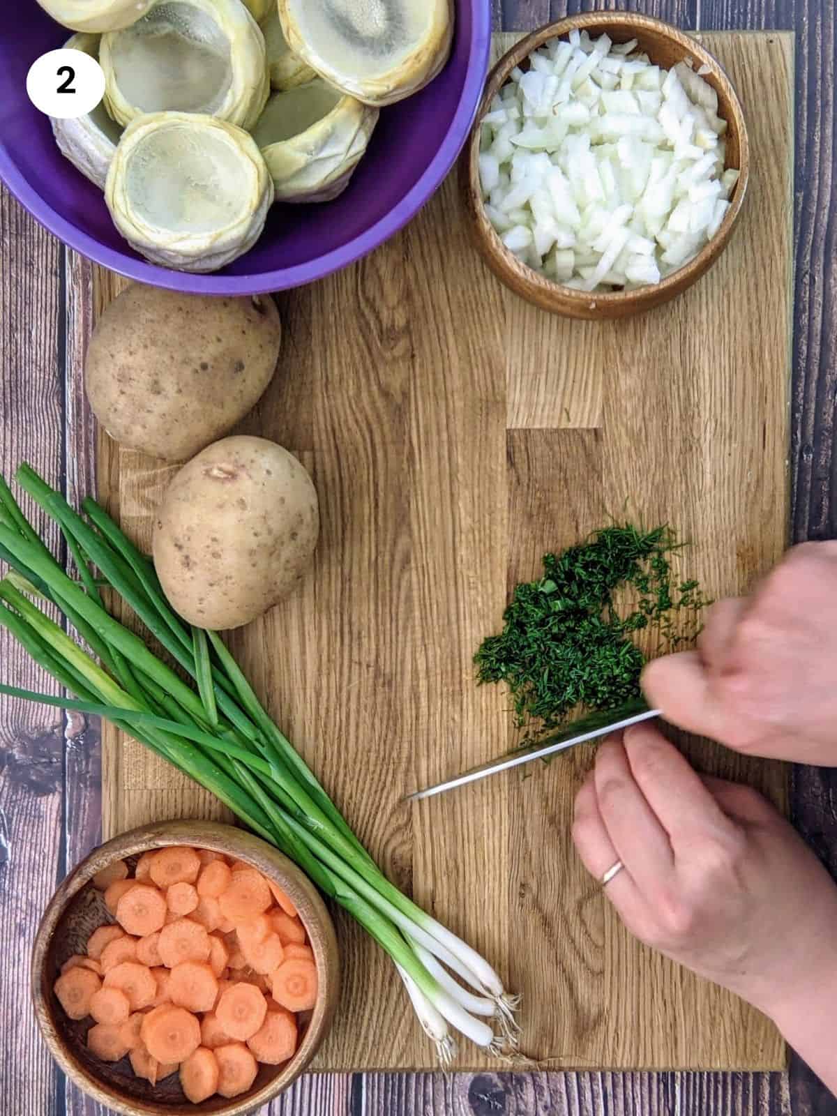 Chopping dill for artichoke stew.