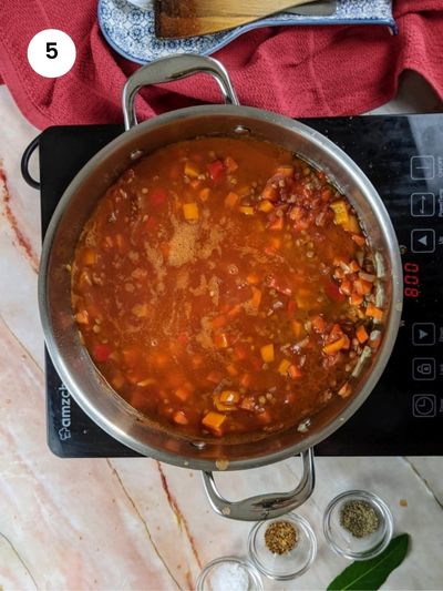 Adding the tomatoes and seasoning.