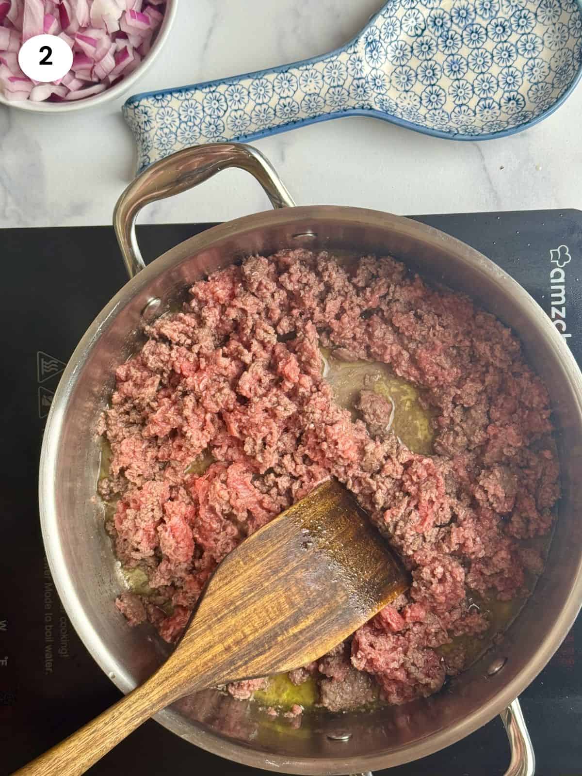 Browning the ground beef in the pot.