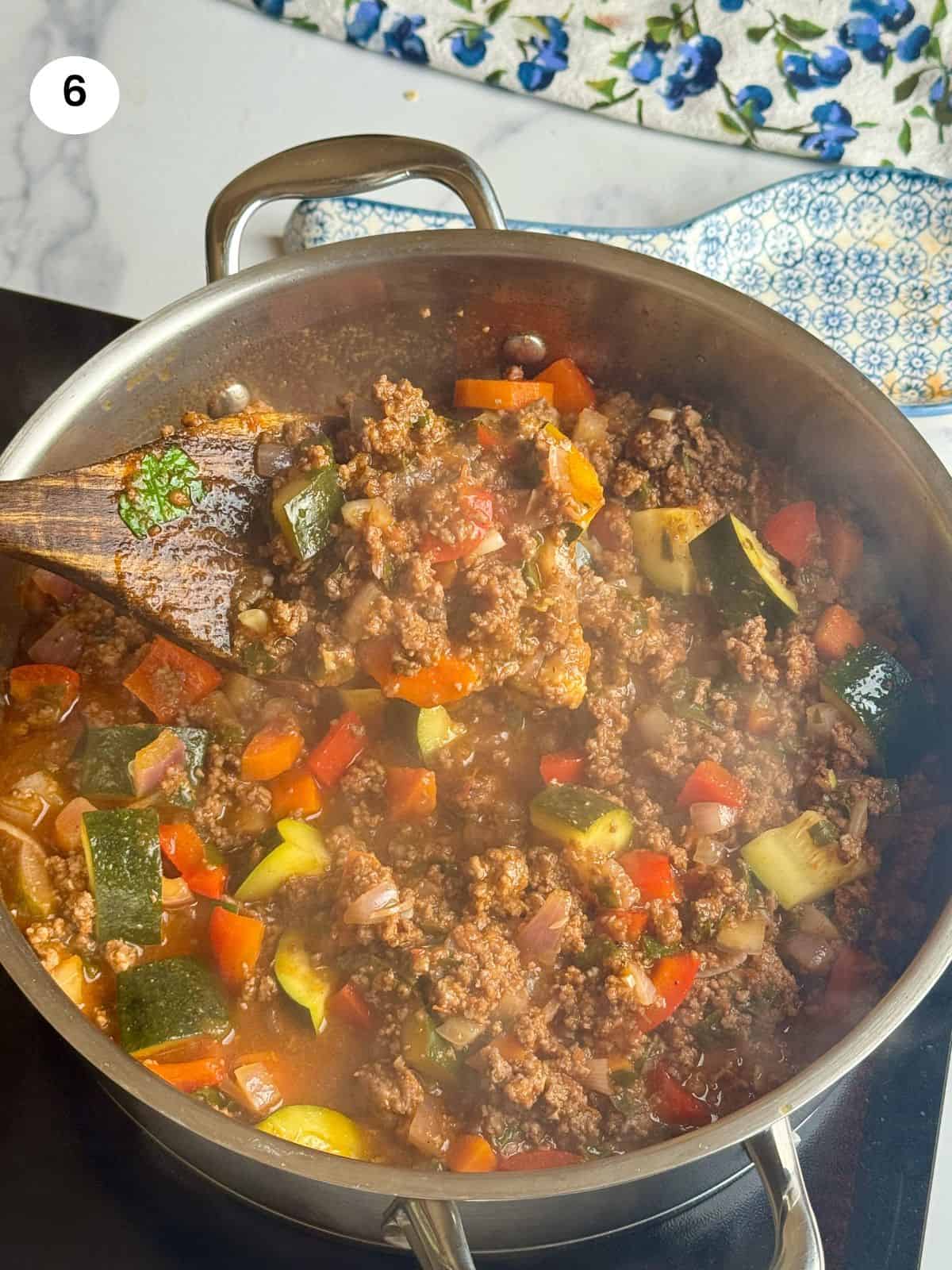 Cooked ground beef with vegetables.