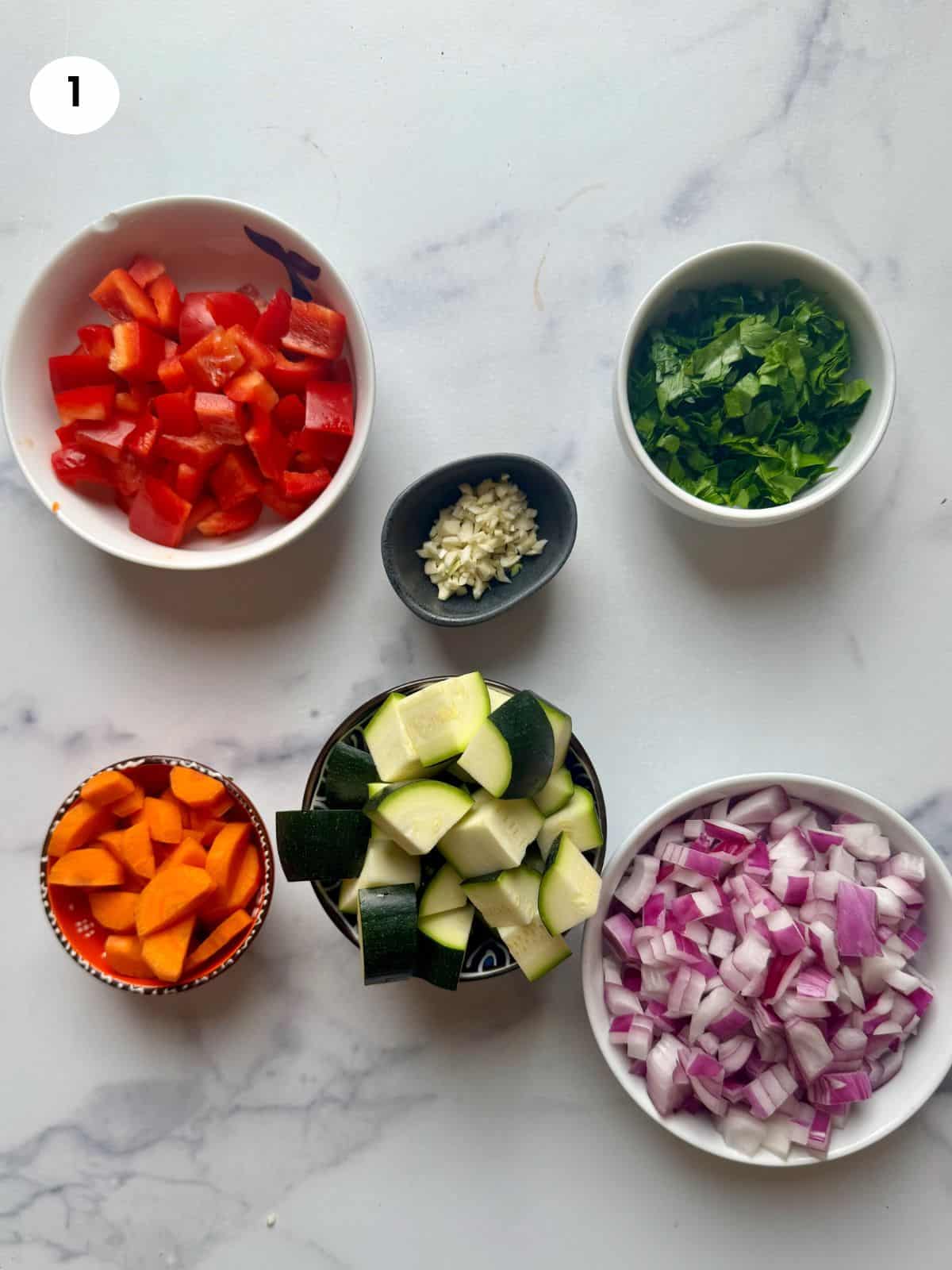 Vegetables for the stew cut and in bowls ready to be cooked.