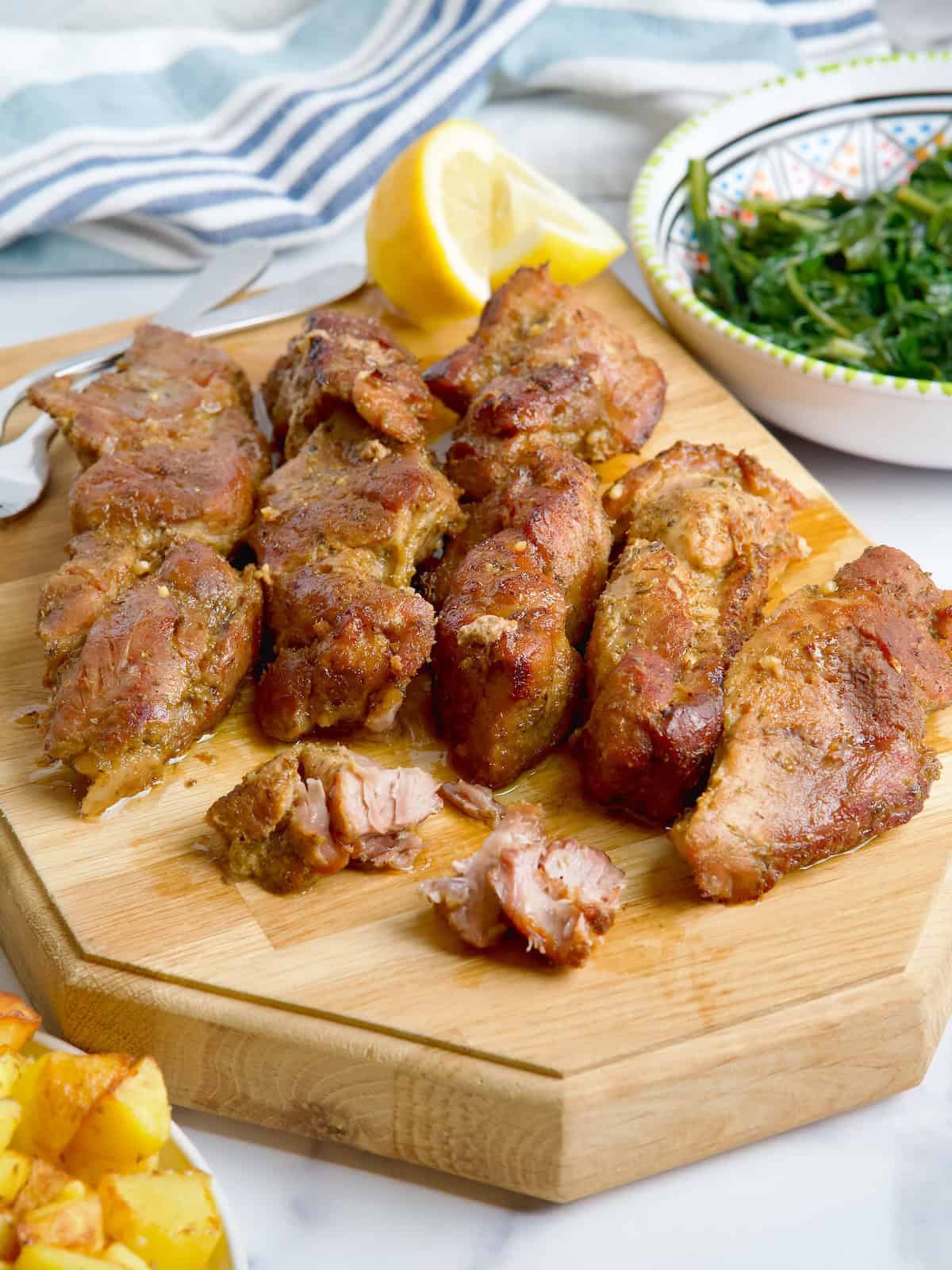 Pork shoulder ribs on a wooden board.