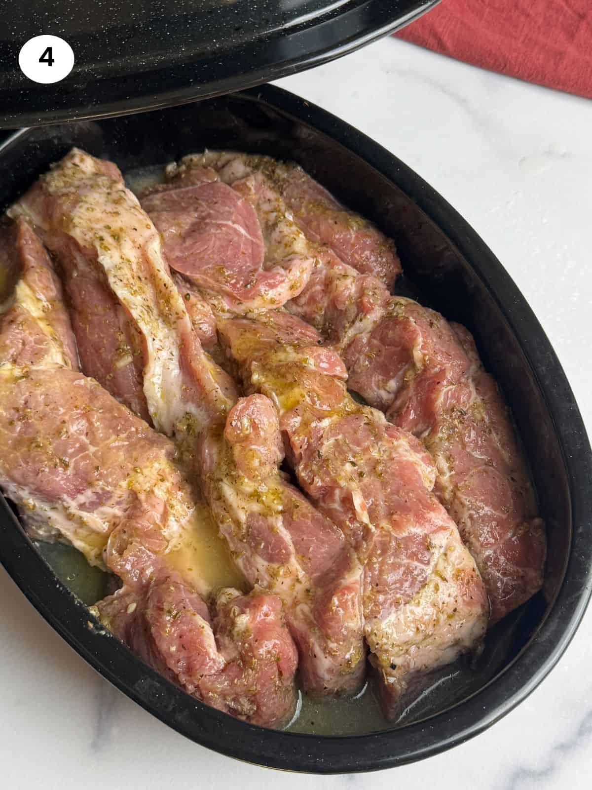 Pork shoulder ribs in the tray ready to go in the oven.