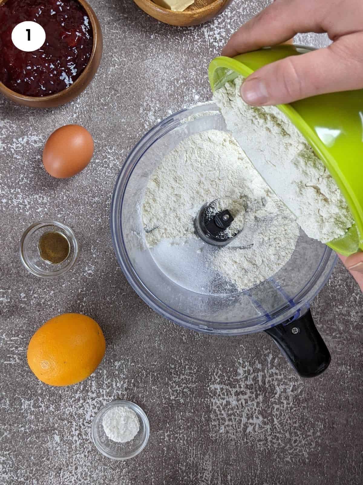 Adding the flour to the food processor bowl.