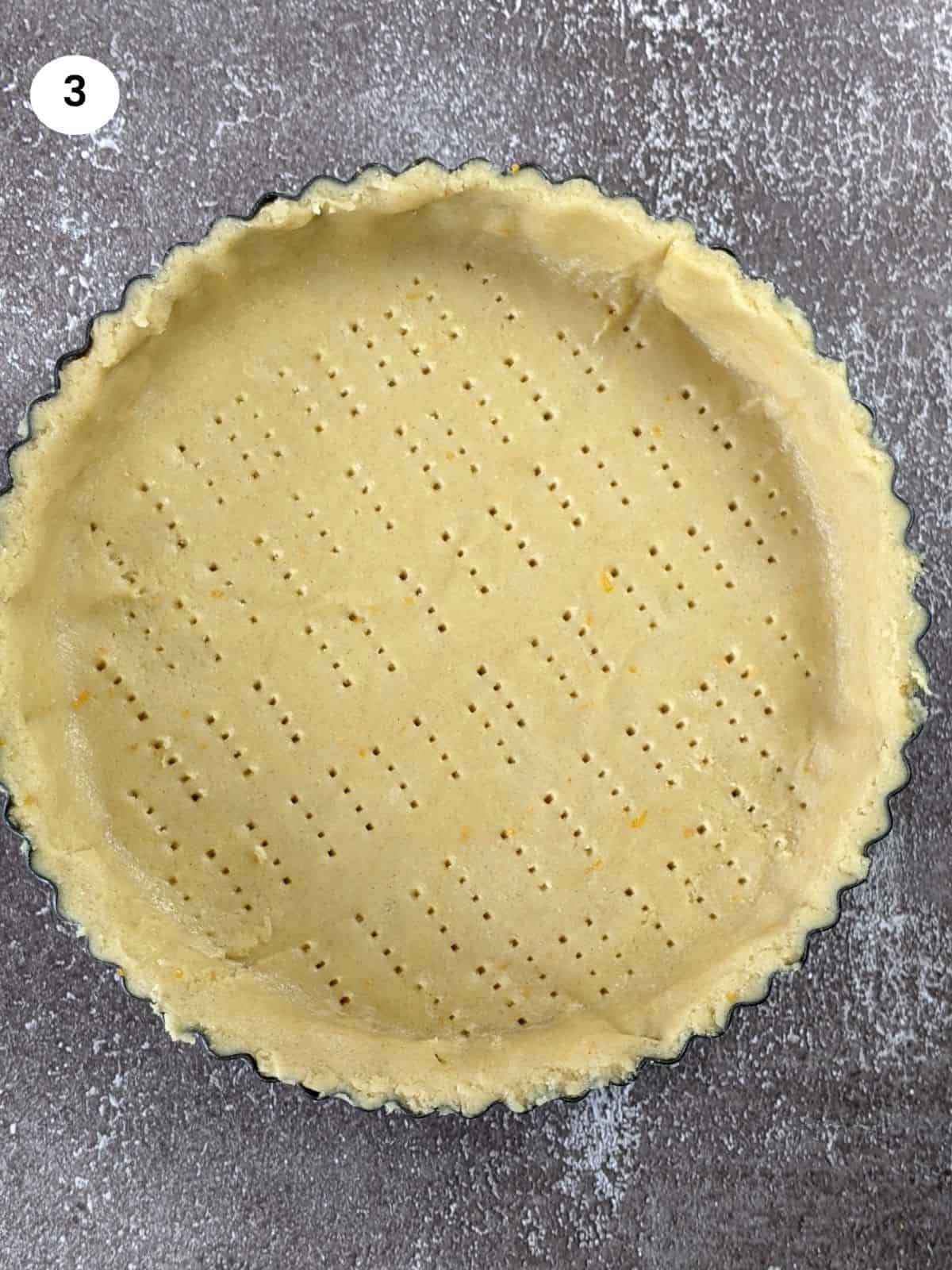 Adding the bottom layer to the tart tin.