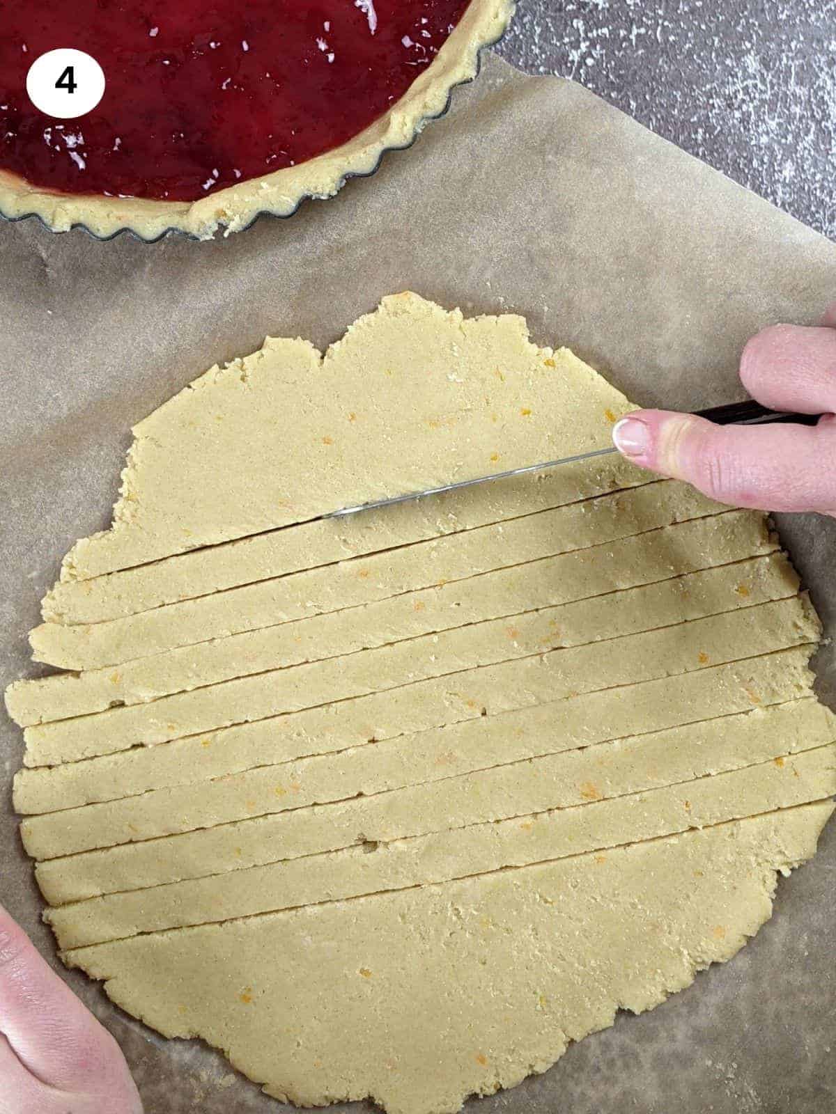 Cutting the rest of the dough into strips to decorate the top of pasta flora.