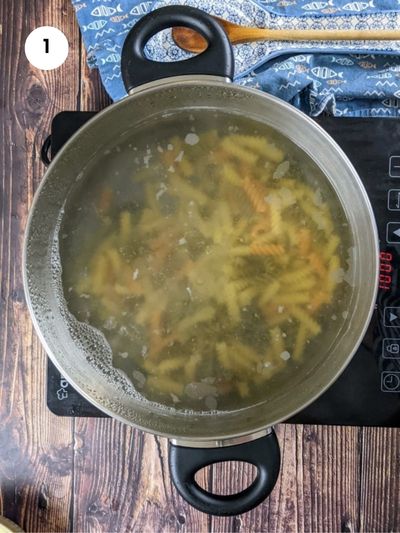 Boiling fusilli pasta.