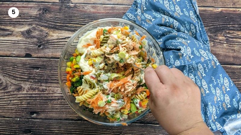 Mixing everything in a big bowl for the fusilli pasta salad.