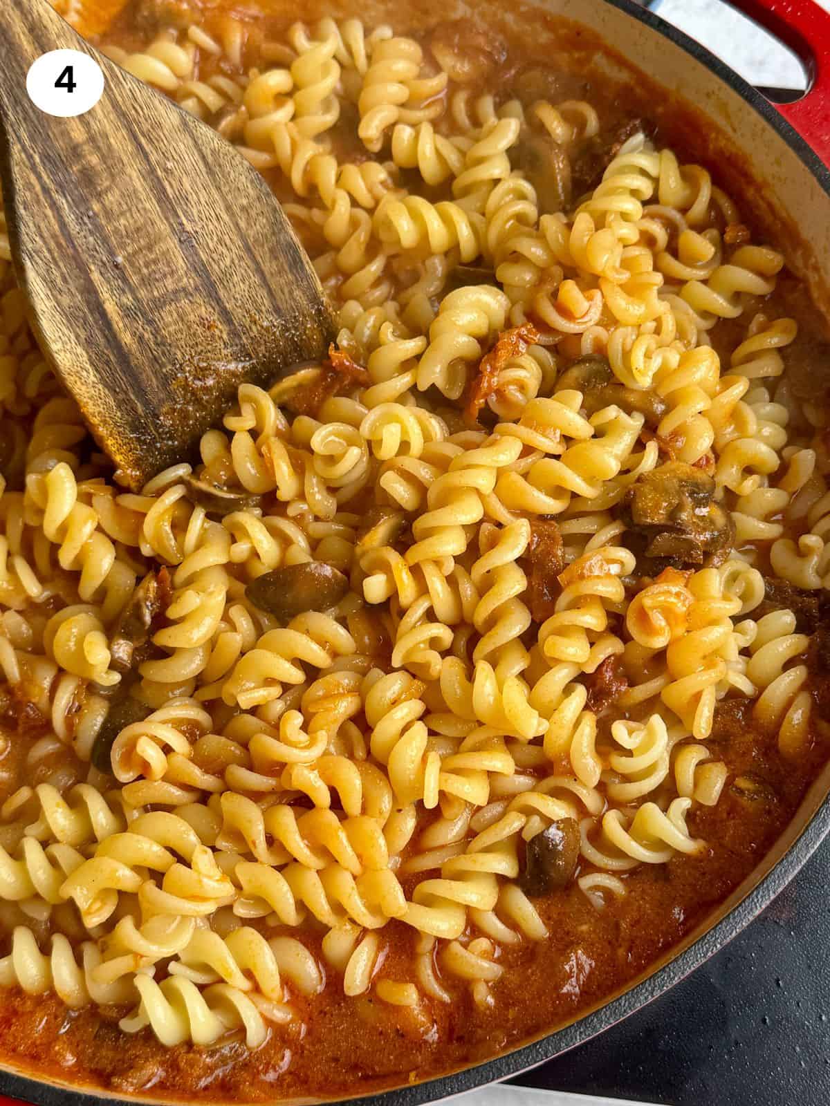 Added the cooked pasta to the pan.