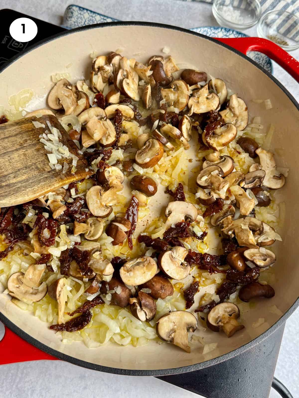 Sauteing the mushrooms and sun-dried tomatoes.